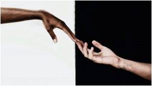 two hands touching against a black and white background