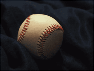 old baseball resting on black fabric